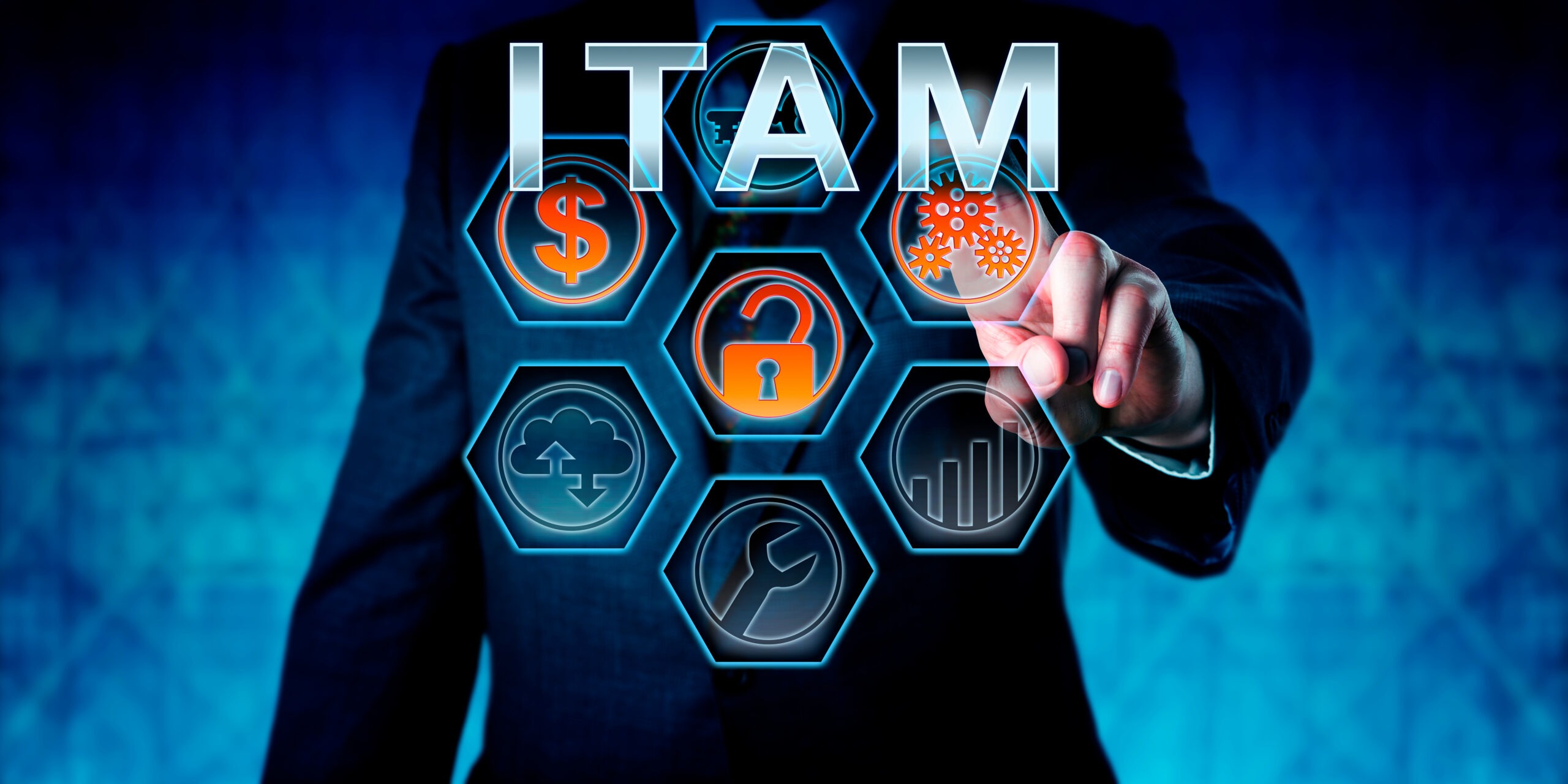 Business person is touching ITAM on an interactive virtual control monitor. Business strategic metaphor, information technology concept, corporate terminology and acronym for IT Asset Management.